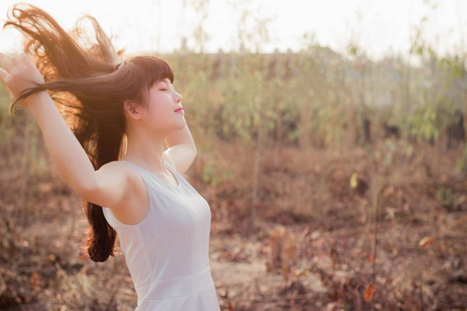Calm person practicing breathing retraining exercise